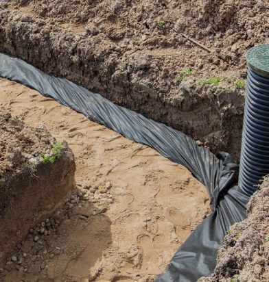 view of drainage pipes and inspection well for removal of water from a site under construction of the house