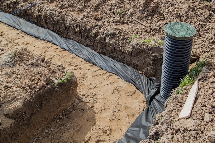 view of drainage pipes and inspection well for removal of water from a site under construction of the house